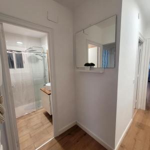 a bathroom with a mirror and a shower at Apartamento en la costa del Maresme in Pineda de Mar