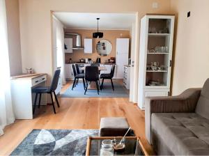 a living room and kitchen with a couch and a table at Kuća Schunko in Duga Resa