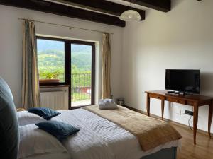 a bedroom with a bed with a television and a window at Belvedere Chalet Bran in Bran +116 photos