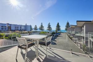 a table and chairs on the balcony of a apartment at Kaikoura Waterfront Apartments in Kaikoura