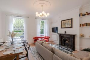 a living room with a couch and a fireplace at Lux and Spacious 4 bedroom apt Camden in London