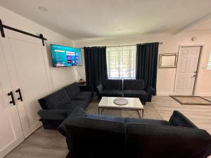 een woonkamer met banken en een flatscreen-tv bij World Connect Miami in Miami