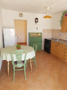 a kitchen with a table and chairs in a kitchen at Taraca 2 in Trpanj