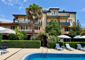 a resort with a swimming pool and a building at Family Hotel Kontesa in Lozenets