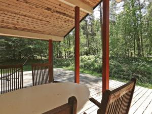 a porch with a table and chairs on a deck at 5 person holiday home in Stege-By Traum in Stege +25 photos