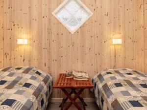 a room with two beds and a table and a window at 3 person holiday home in Karrebæksminde-By Traum in Karrebæksminde