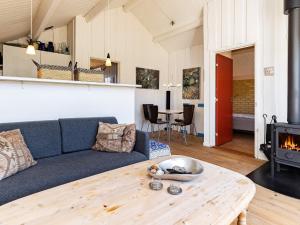 a living room with a couch and a table at Two-Bedroom Holiday home in Askeby 2 in Askeby