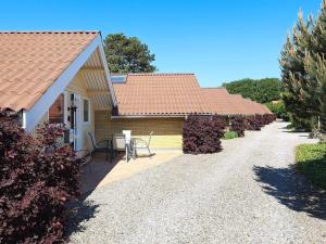 a house with a pathway leading to the front yard at Two-Bedroom Holiday home in Askeby 2 in Askeby