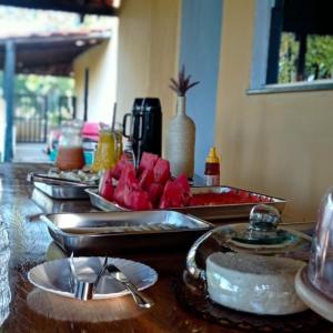 a table with plates of food on top of it at Pousada Diadorim in Sao Domingos de Goias