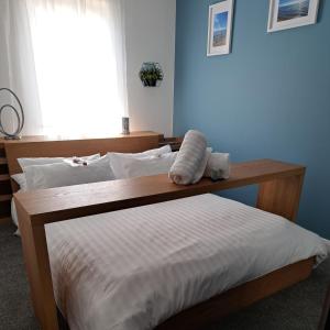 a bedroom with a bed with a wooden head board at The Wee Bunker in Barassie