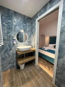 a bathroom with a sink and a bed at San Ferdinando suite room in Naples