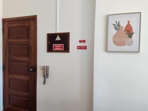 a room with a door and some pictures on the wall at Apartment by the beach! With large balcony! in São Martinho do Porto
