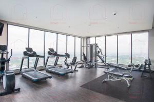 a gym with cardio equipment in a building with windows at LUXURY CONDO RM99 HILL10 ICITY 2BD FREE PARKING in Kampong Padang Jawa