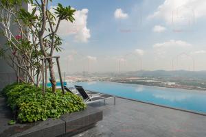 a chair on the edge of a building with a pool at LUXURY CONDO RM99 HILL10 ICITY 2BD FREE PARKING in Kampong Padang Jawa