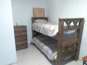 a small bedroom with a bunk bed and a dresser at Alquiler de casa in Las Heras