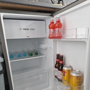 een open koelkast gevuld met veel drankjes en frisdranken bij The Wee Bunker in Barassie