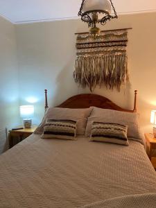 a bedroom with a large bed with two pillows at Nevados de chillan , edificio los coigues in Nevados de Chillan