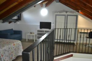 a room with a staircase with a bed and a tv at El Molino 3 in Muros de Nalón
