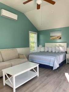 a bedroom with a bed and a couch at The Grand Beach Inn in Old Orchard Beach