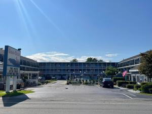 a parking lot in front of a large building at Grand Beach Inn in Old Orchard Beach