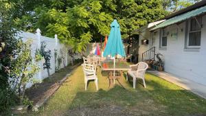 a table and chairs and an umbrella in a yard at Falls Motel in Niagara Falls