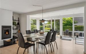 a dining room with a table and chairs at Amazing Home In Rudkbing With Wifi in Spodsbjerg