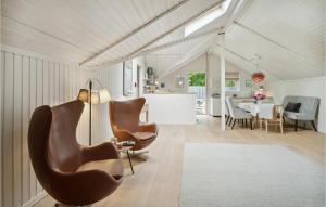 a living room with leather chairs and a table at Lovely Home In Sklskr With Kitchen in Skælskør