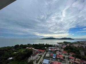 an aerial view of a city and the ocean at Inns Homestay in Sandakan