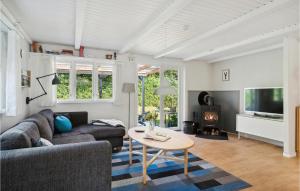 a living room with a couch and a table at 3 Bedroom Beautiful Home In Struer in Struer