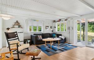 a living room with a couch and a table at 3 Bedroom Beautiful Home In Struer in Struer