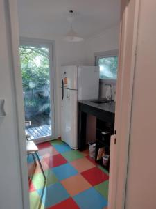 eine Küche mit einem farbenfrohen Boden und einem Kühlschrank in der Unterkunft El parquecito in Tandil