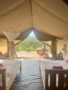 two beds in a tent with a view at Sunset camp in Narok