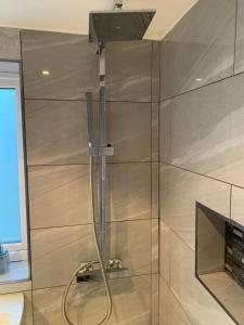 a shower with a shower head in a bathroom at Deluxe Double Room with Private Amenities in Banbury