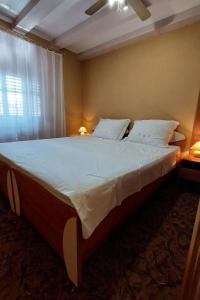 a large bed in a bedroom with a window at Apartments by the sea Cres - 21117 in Cres