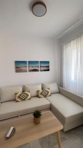 a white living room with a couch and a table at costa ballena elite in Costa Ballena