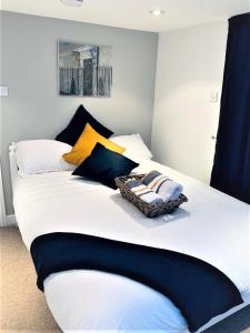 a bedroom with a large white bed with colorful pillows at Deluxe Double Room with Private Amenities in Banbury