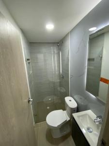 a bathroom with a toilet and a shower and a sink at HOTEL ESTADIO DORADO in Medellín