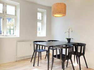 a dining room with a black table and chairs at 1 Bedroom Apartment In Kolding City Center in Kolding