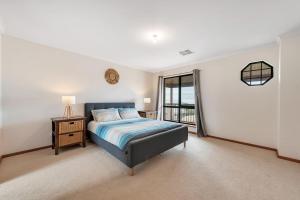 a large bedroom with a bed and a window at 10 Rupara - Linen Included in Hayborough
