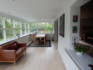 a living room with a couch and a table at Kummelefort in Kruså