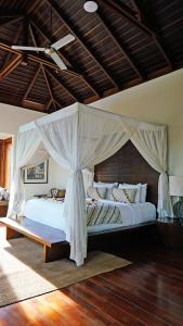 a bedroom with a large bed with a canopy at The New Villa Suar in Seminyak