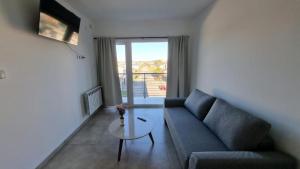a living room with a couch and a table at Departamento Rivadavia in Olavarría