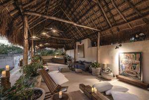 a living room with a couch and chairs in a resort at Casa Kacaya in Espita