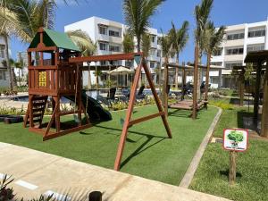 a playground at a resort with a slide at Nuevo Departamento con Excelente Ubicación y Muy Bonita Alberca - Residencial Almarena II in Mazatlán