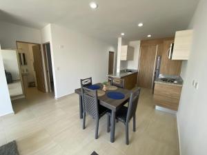 a kitchen and dining room with a table and chairs at Nuevo Departamento con Excelente Ubicación y Muy Bonita Alberca - Residencial Almarena II in Mazatlán +11 photos