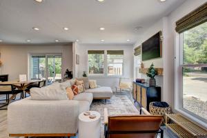 a living room with a couch and a tv at Off-Broadway - Modern woutdoor haven in Boise