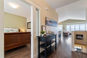 a living room with a desk and a bedroom at 3 bed, 2 bath upper suite overlooking the city in Vernon