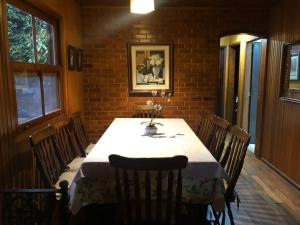 a dining room with a table and some chairs at SITIO SIMPLESMENTE DEMAIS in Nova Friburgo