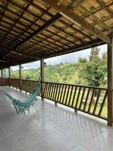 a hammock on a screened in porch with a view at Casa da Serra Negra in Bezerros