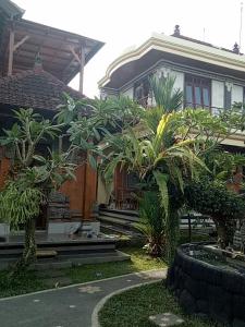 a house with some trees in front of it at Uma Pejeng in Ubud